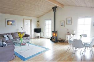 a living room with a couch and a table at 7000-Bogo-By-Mosedalen-6 in Bogø By