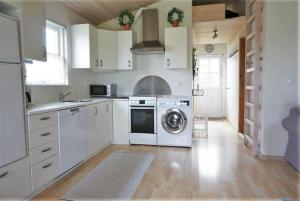 a kitchen with a washer and dryer in it at 7000-Bogo-By-Mosedalen-6 in Bogø By