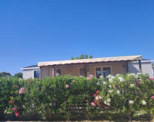 a house with flowers in front of it at Chez lolo 7 à 8 personnes in Sérignan +3 photos