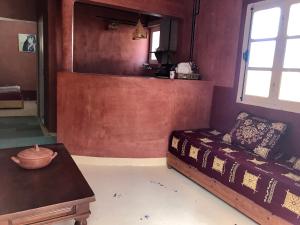 a room with a bed and a table and a window at Gite Le Nomade in Mirleft +37 photos