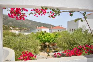 a view from the balcony of a villa with pink flowers at Kyfanta, studios & apartments in Kyparissi in Kiparission