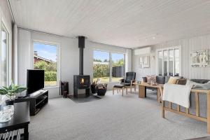 a living room with a couch and a fireplace at OH412-Hadsund-Halvrebene-94 in Hadsund