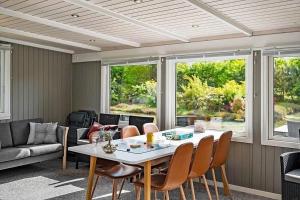 a living room with a table and chairs at OH412-Hadsund-Halvrebene-94 in Hadsund