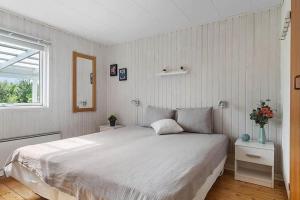 a bedroom with a large white bed and a window at OH412-Hadsund-Halvrebene-94 in Hadsund