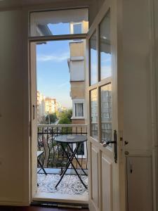 a door leading to a balcony with a table and a view at Şah Bey Konağı in Istanbul