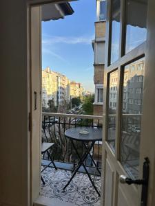a balcony with a table and a view of a city at Şah Bey Konağı in Istanbul