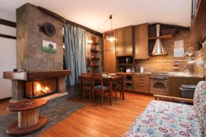 a kitchen with a fireplace in the middle of a room at Zavaglia House in Lainate