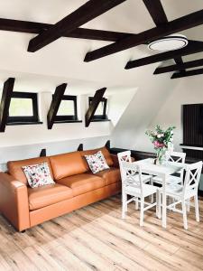 a living room with a couch and a table at Apartmány Haberschie in Řehlovice