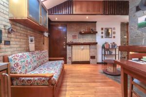 a living room with a couch and a brick wall at Zavaglia House in Lainate