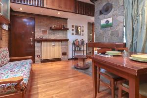 a living room with a table and a stone wall at Zavaglia House in Lainate +4 photos