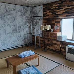 a living room with a table and a window at Hakodate Guest House in Hakodate