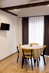 a dining room with a table and chairs at My Home Apartments in Berehove