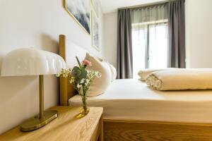 a bedroom with a bed and a table with a lamp at Elbblick Premium-Apartment zentral in Dresden in Dresden