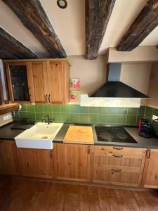 a kitchen with a sink and a stove top oven at Casa Robelca in Biescas +39 photos