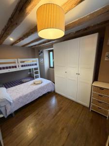 a bedroom with a bunk bed and a ceiling at Casa Robelca in Biescas