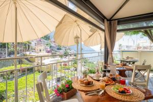 a dining room with a table with food and umbrellas at Florida Residence in Positano