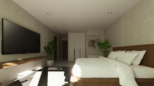 a bedroom with a large bed and a flat screen tv at LIB LIB Lio in El Nido