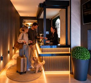 a group of people with a dog in a restaurant at Sleephotels Cosmos in Hamburg