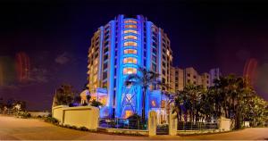 a building is lit up in blue at night at Suncoast Hotel & Towers in Durban