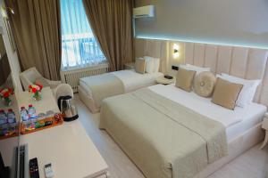 a hotel room with two beds and a window at Chukhur Gabala Museum Hotel in Gabala +97 photos