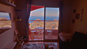 a room with a balcony with a view of the ocean at Chalet in Porto Sokhna Hanging Gardens - Fifth Terrace Sea View شاليه في بورتو السخنة - الحدائق المعلقة - المصطبة الخامسة - إطلالة بحر مباشر in Ain Sokhna