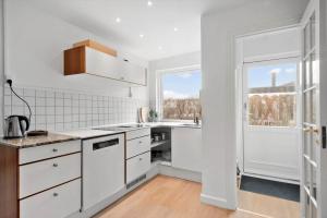a white kitchen with a sink and a window at S754-Stroby-Ladeplads-Svalemosevej-84 in Strøby Ladeplads +16 photos