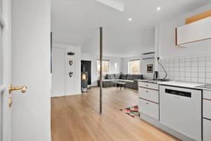 an open kitchen and living room in a white apartment at S754-Stroby-Ladeplads-Svalemosevej-84 in Strøby Ladeplads