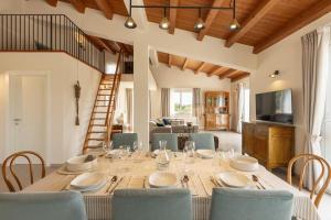 a dining room with a long table and chairs at Villa Lumiere in Modica