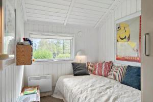 a bedroom with a bed and a window at 3064-Stege-Maegleren-34 in Stege