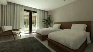 a bedroom with two beds and a desk and a window at LIB LIB Lio in El Nido