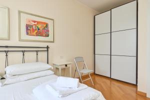 a bedroom with a bed and a chair and a desk at The Lake Balcony by Gardenjoy in Brenzone sul Garda