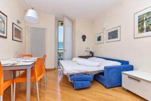 a bedroom with a bed and a table and chairs at The Lake Balcony by Gardenjoy in Brenzone sul Garda +19 photos