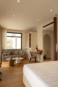 a hotel room with a bed and a couch at Aetheria Boutique Hotel & Spa in Markopoulo +63 photos