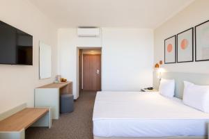 a hotel room with a bed and a desk at SOL by Meliá Nessebar Mare All Inclusive in Nesebar