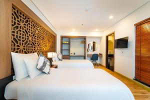 a hotel room with two beds and a tv at Gemini Saigon LUXURY in Ho Chi Minh City +51 photos