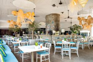 a dining room with tables and chairs and chandeliers at Hard Rock Hotel Pattaya in Pattaya