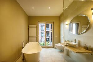a bathroom with a sink and a toilet and a mirror at Elbblick Premium-Apartment zentral in Dresden in Dresden +5 photos