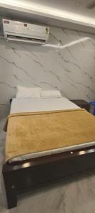 a bed in a room with avertisement at RVS Residency in Kāyalpattinam +15 photos