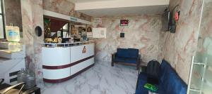 a restaurant with a counter and a blue chair at RVS Residency in Kāyalpattinam