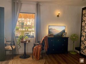 a living room with a dresser and a window at LV Homestay in Nha Trang
