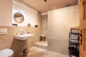 a bathroom with a sink and a toilet and a mirror at Gästehaus Kaltenbach in Staufen im Breisgau +52 photos
