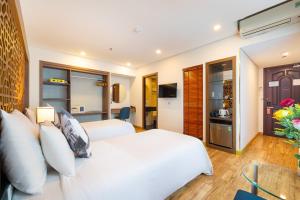 a bedroom with a white bed and a living room at Gemini Saigon LUXURY in Ho Chi Minh City