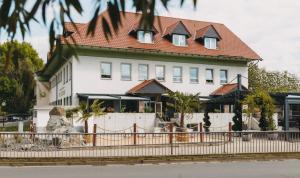 a large white house with a red roof at Monteurzimmer in Nordhausen +17 photos