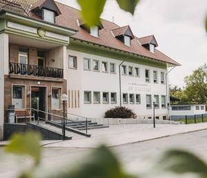 a large white building with a brown roof at Monteurzimmer in Nordhausen