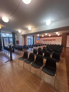 a large room with chairs and a podium in it at Cascina Scova Resort in Pavia +131 photos
