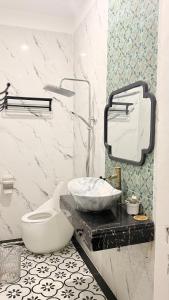 a bathroom with a toilet and a sink on a counter at LV Homestay in Nha Trang +42 photos