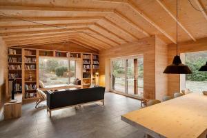 a living room with a wooden ceiling and a table at 2314-Stege-Ulvshale-Cedervej-4-B in Tyrholm
