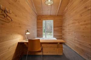 a wooden room with a desk and a window at 2314-Stege-Ulvshale-Cedervej-4-B in Tyrholm