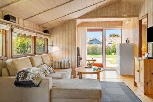 a living room with a couch and a table at 8256-Vordingborg-Kastaniegardsvej-4 in Vordingborg