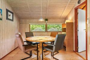 a dining room with a table and chairs at 8256-Vordingborg-Kastaniegardsvej-4 in Vordingborg +11 photos